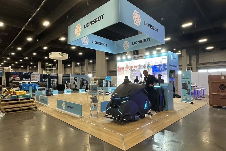 Visitors viewing the Lionsbot island booth at ISSA Show 2025