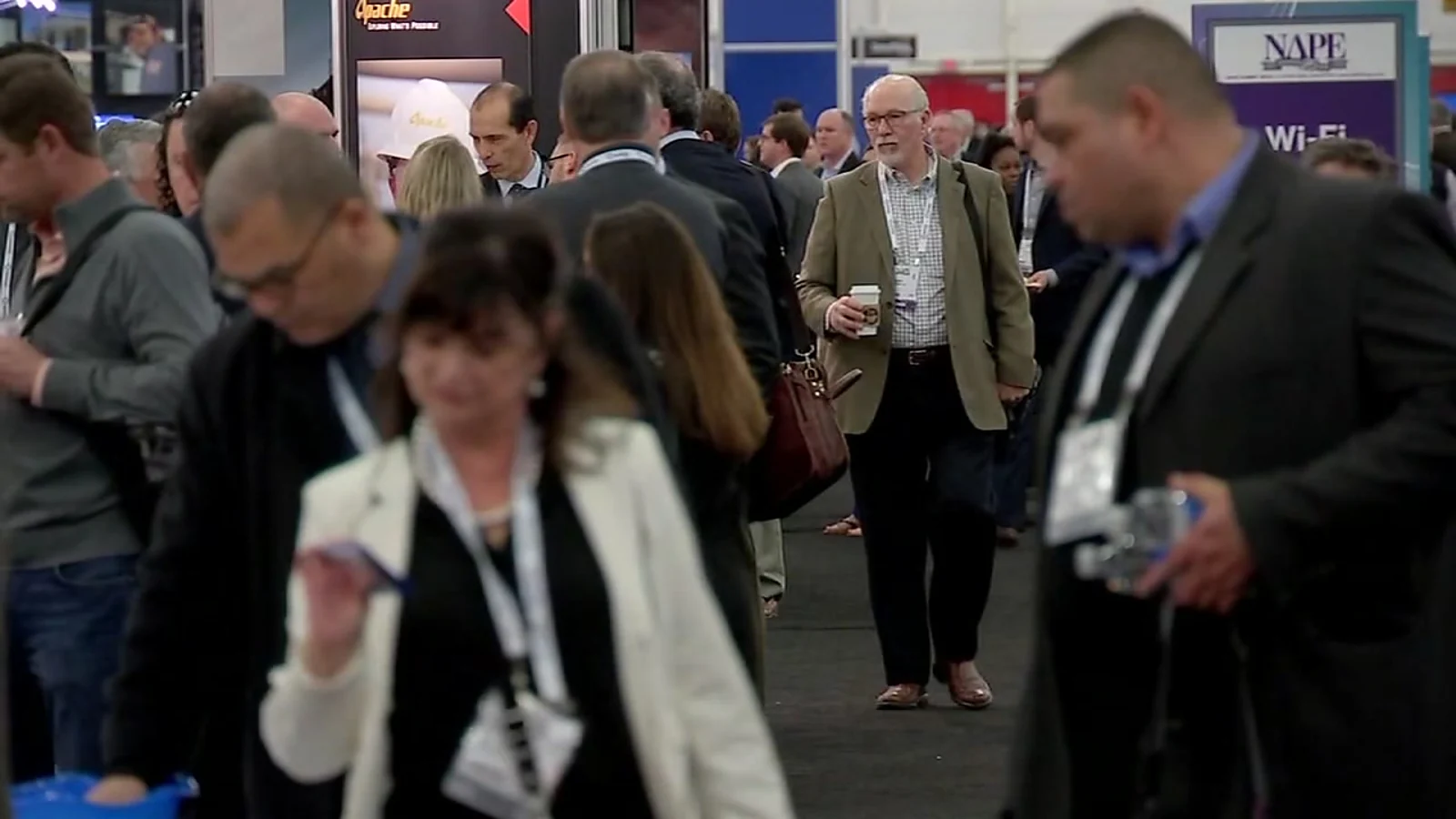 Energy professionals network on the NAPE Summit exhibition floor in Houston.