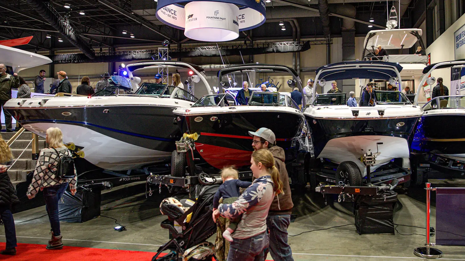 Boats and visitors across the indoor Seattle Boat Show floor