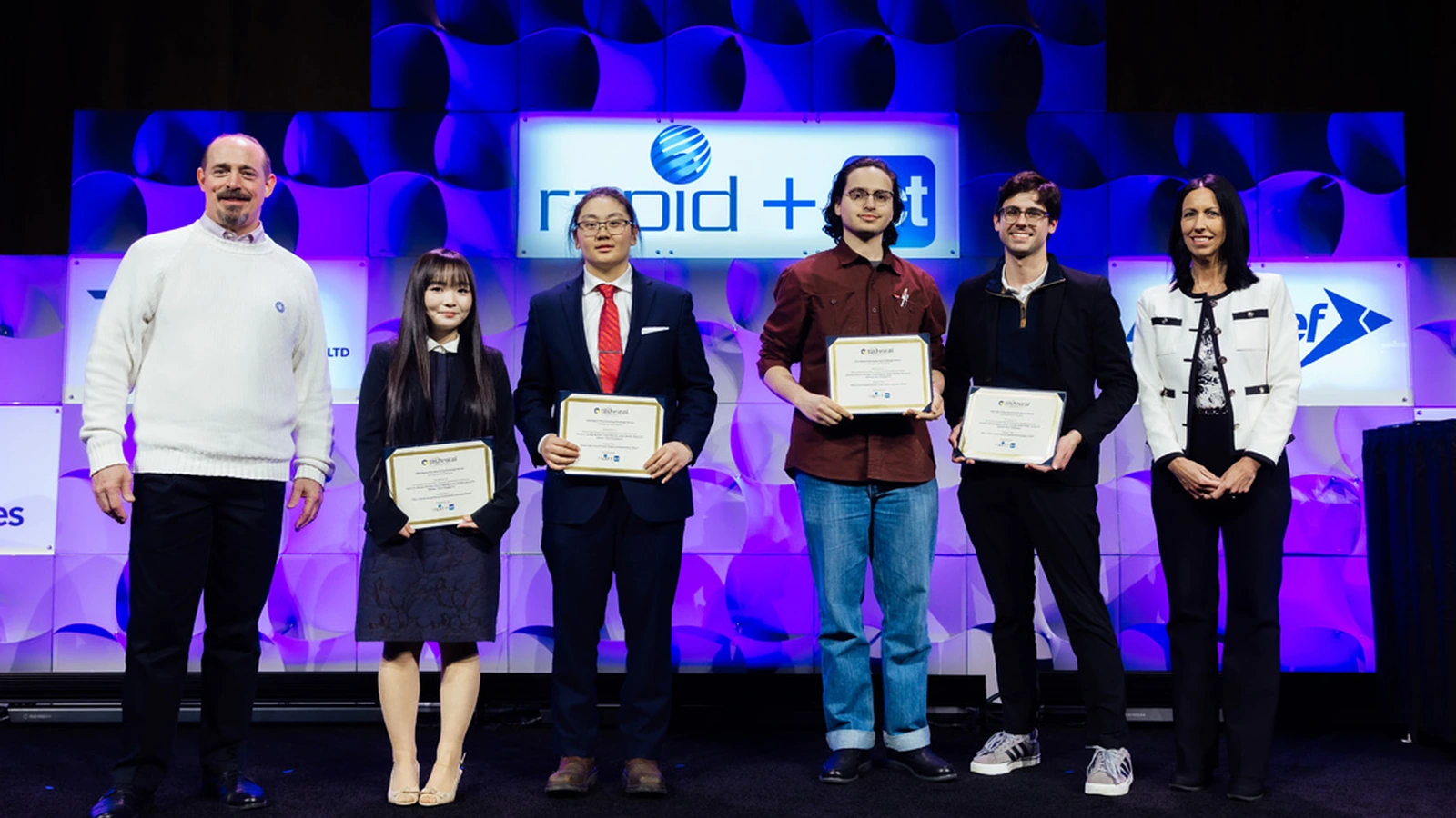 Award recipients pose before a RAPID + TCT 2025 stage backdrop.