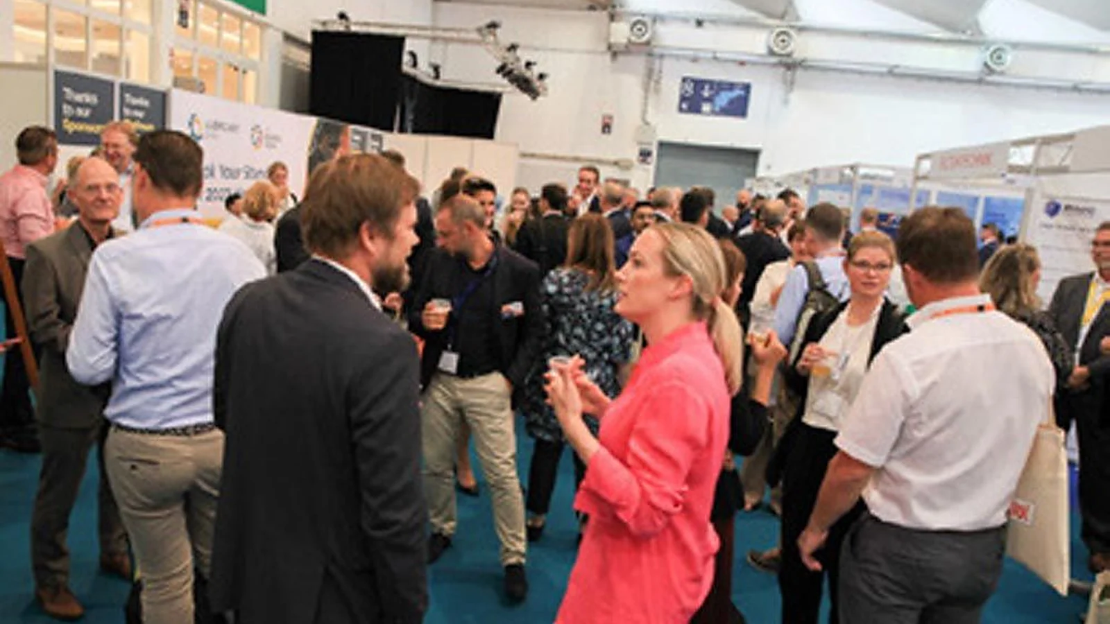 Bearing industry professionals network on The Bearing Show exhibition floor.