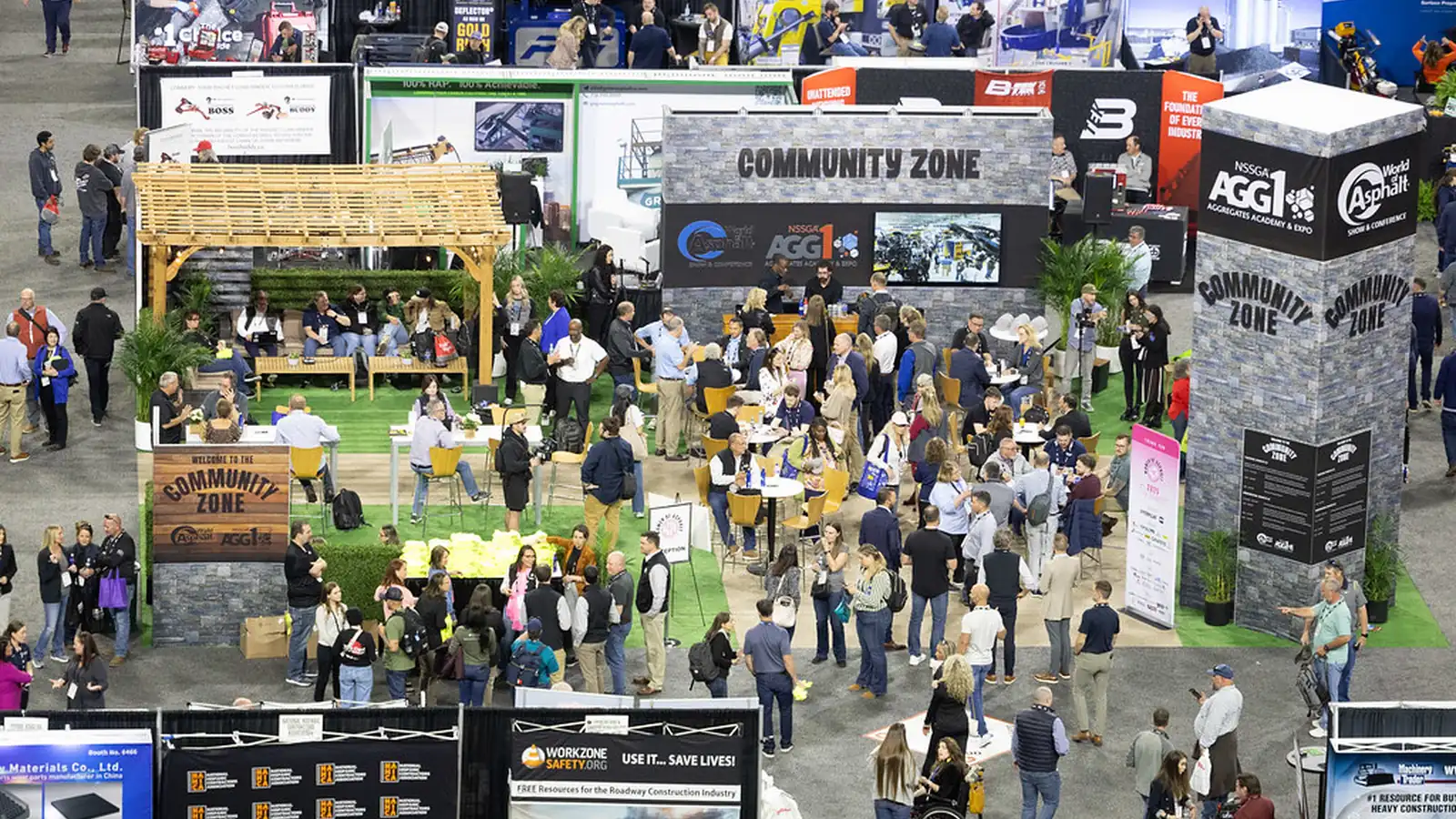 World of Asphalt and AGG1 attendees gather around equipment and the Community Zone on the show floor.