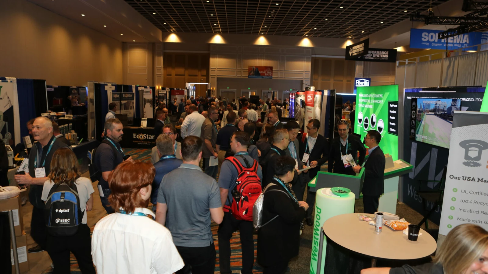 Attendees speak with exhibitors on the busy IIBEC International Convention trade show floor.