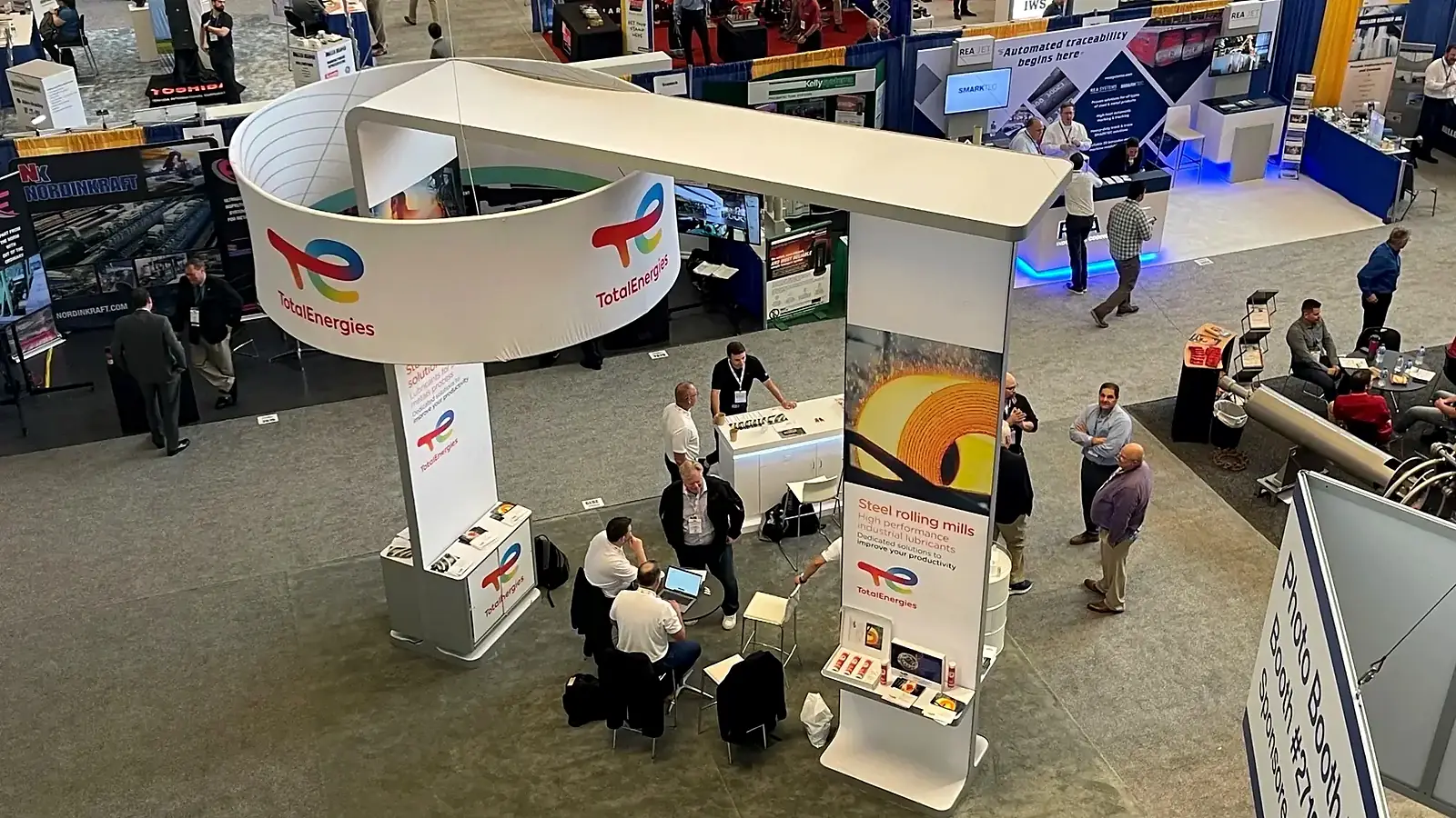 AISTech expo floor with steel industry booths and attendees