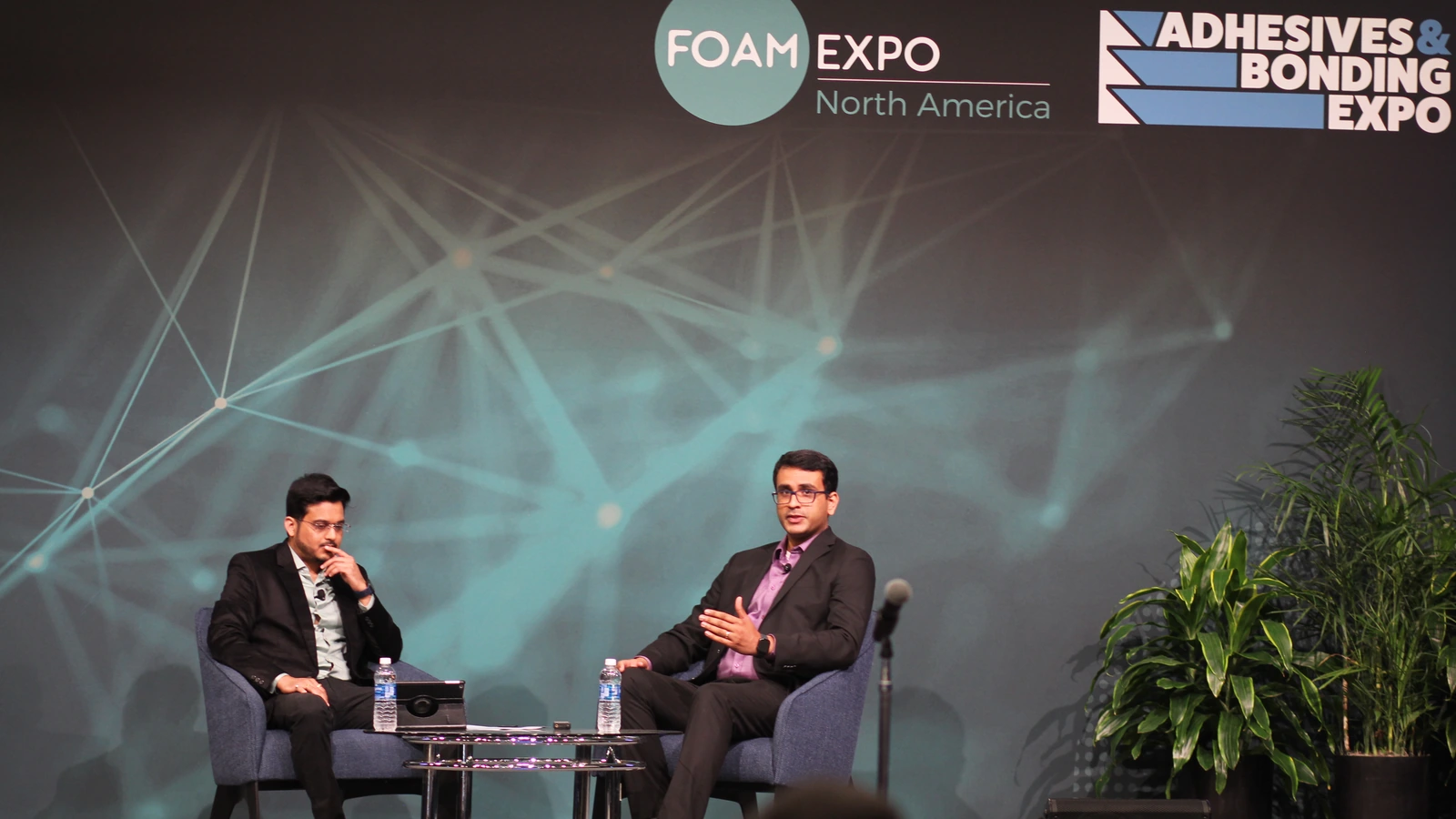 Panelists sit before the Foam Expo North America stage backdrop.