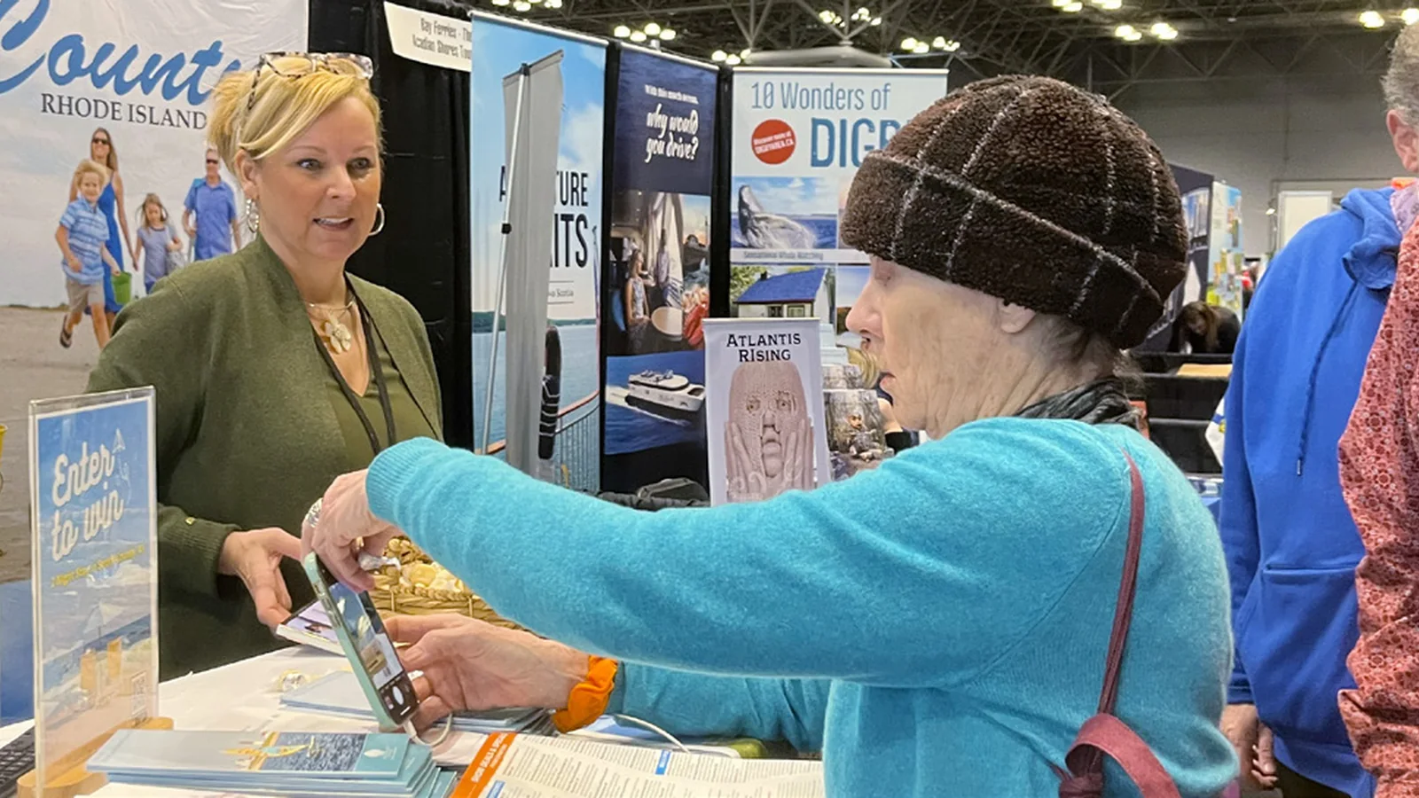 Visitor speaking with an exhibitor at the Seattle Travel and Adventure Show