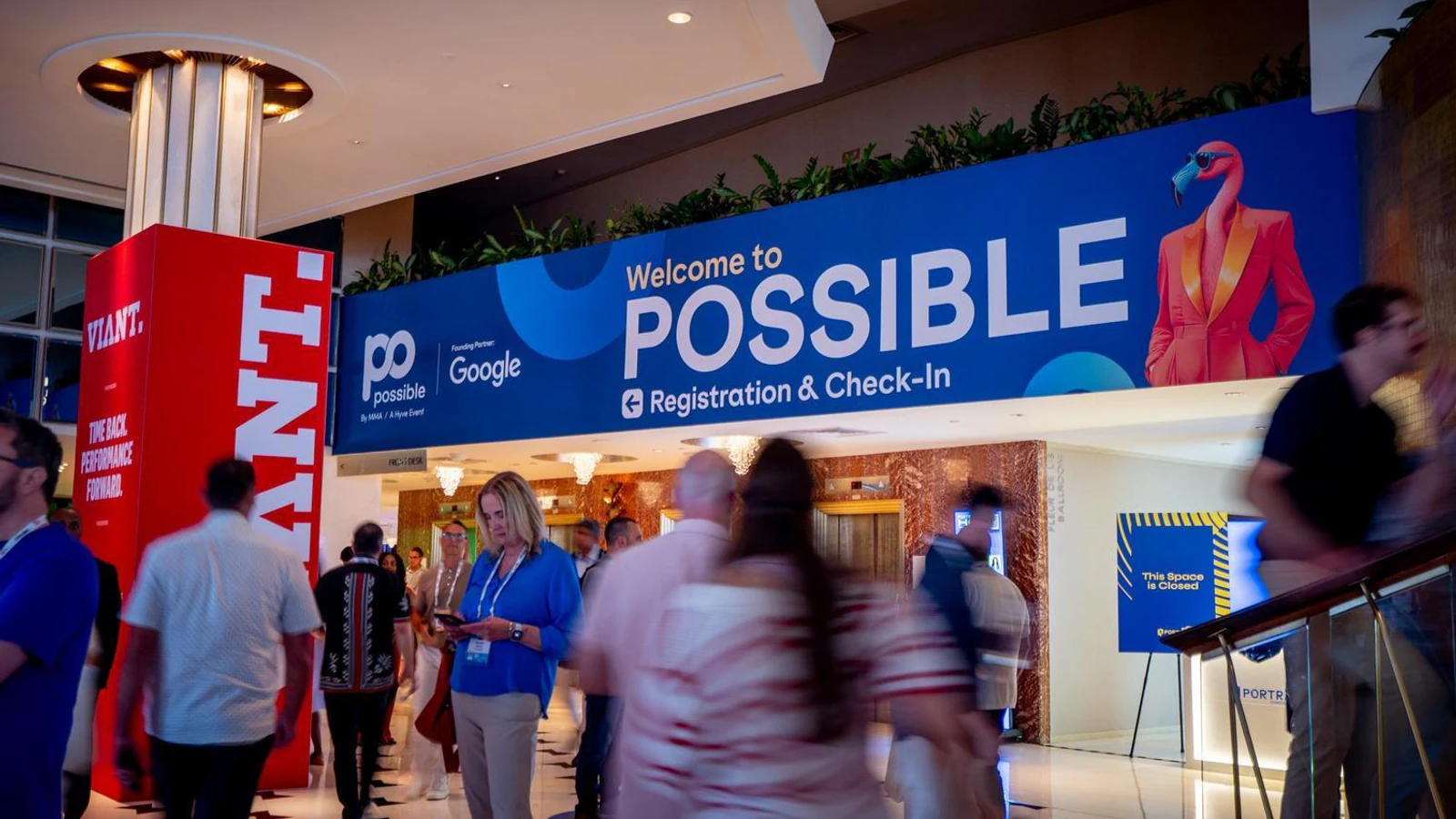 Attendees arrive beneath the POSSIBLE registration and check-in banner in Miami.