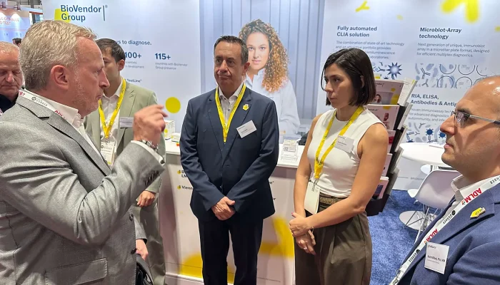 Laboratory professionals talk at an exhibitor booth during ADLM 2025 in Chicago.