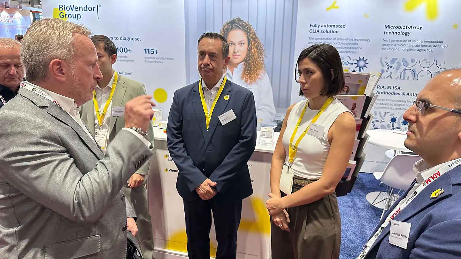 Laboratory professionals talk at an exhibitor booth during ADLM 2025 in Chicago.