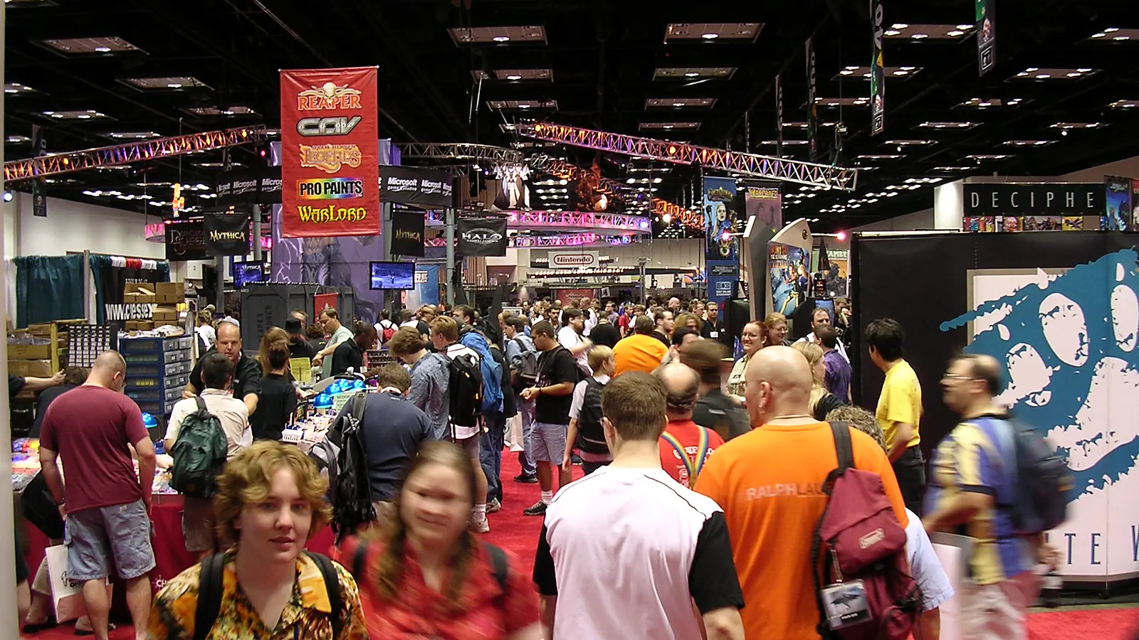 Gen Con Indy exhibit hall in Indianapolis with gaming booths and attendees
