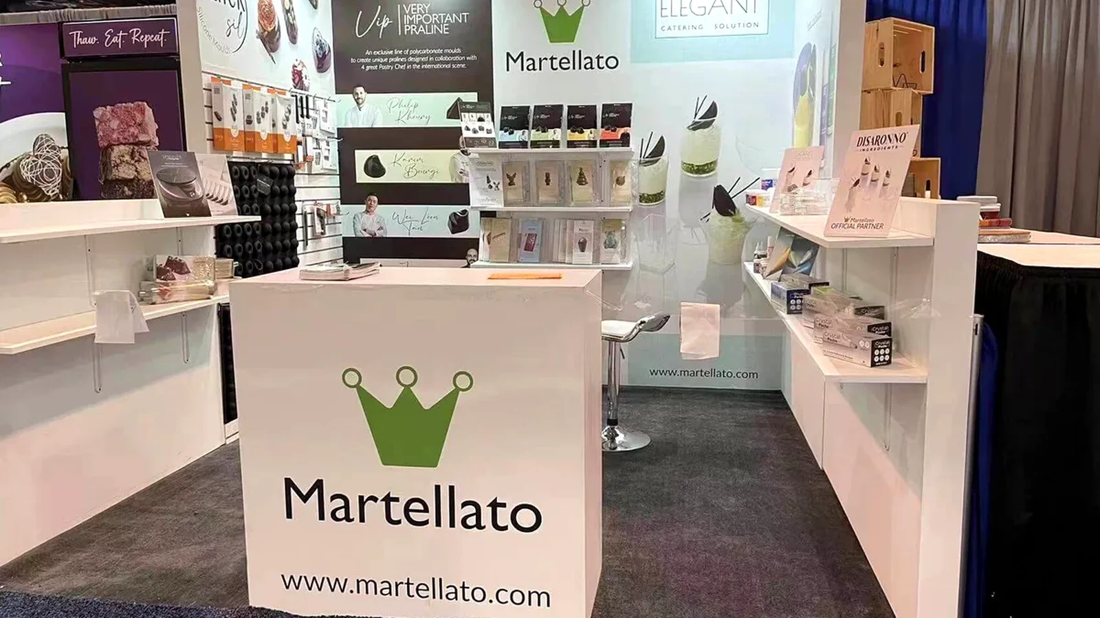 Martellato 10x10 booth with retail-style shelving, product displays and a front reception counter.