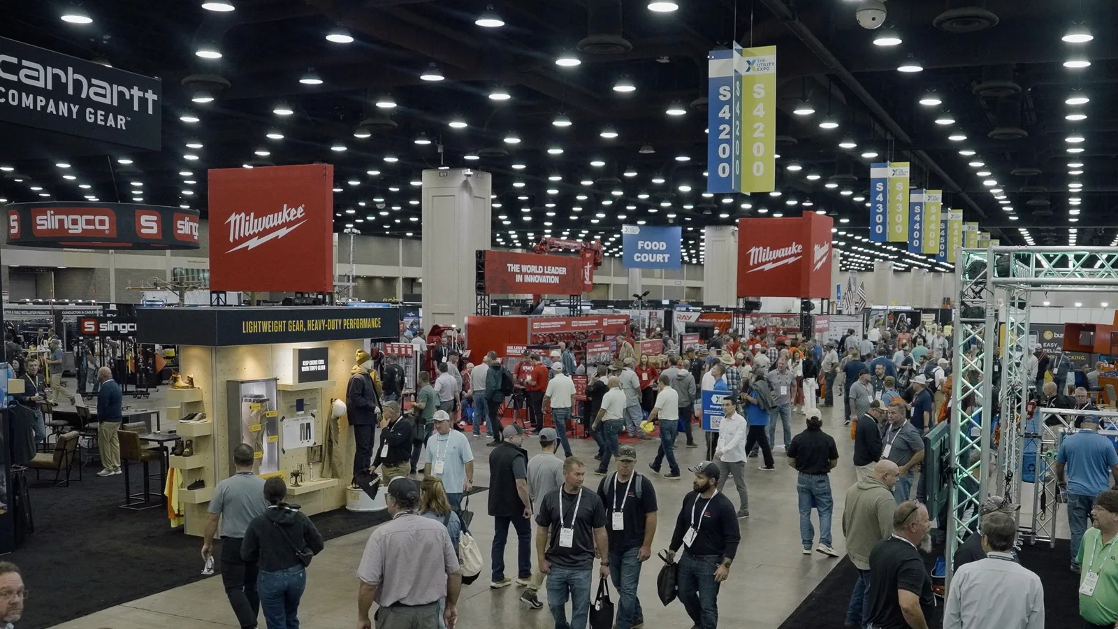 Crowded indoor exhibit hall at The Utility Expo with tool and equipment booths.
