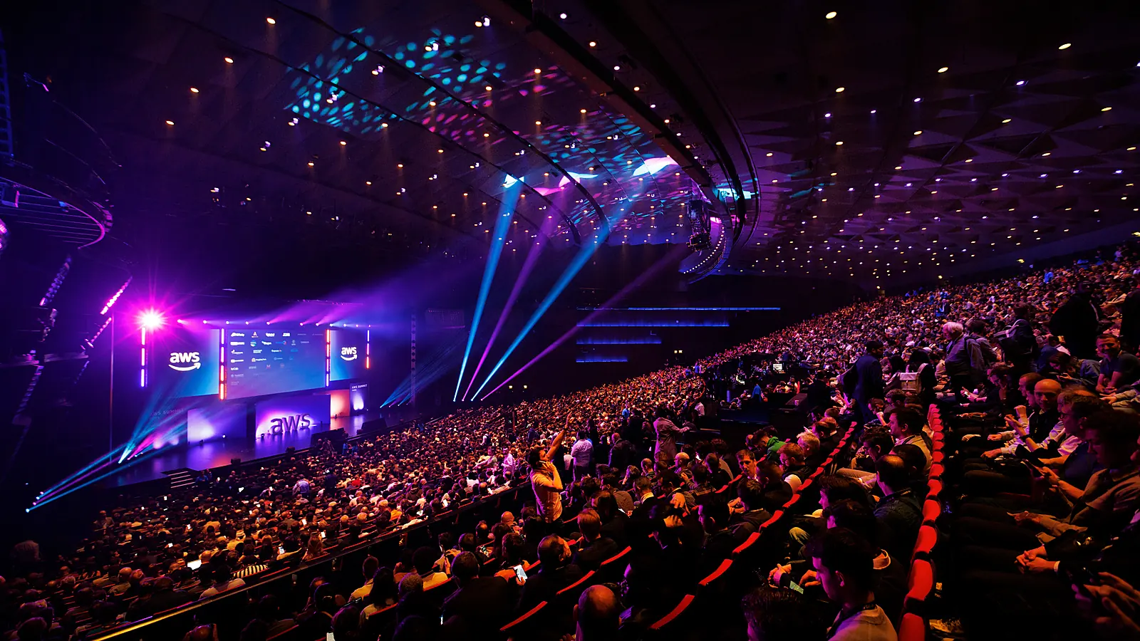 A large audience attends an AWS Summit keynote in Paris.
