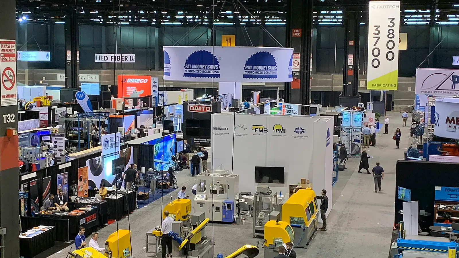 Machinery exhibits and visitors fill the FABTECH show floor in Chicago.