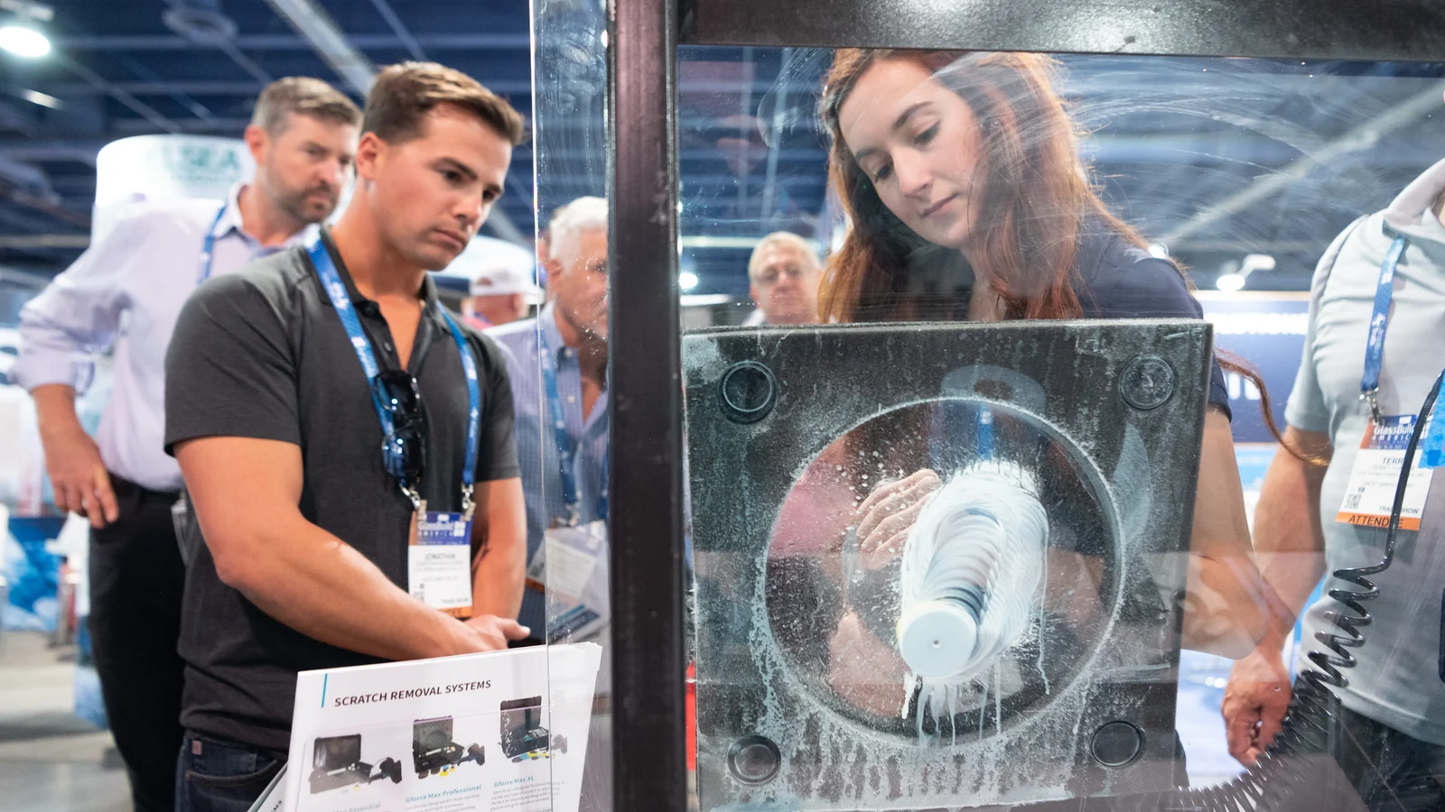 Attendees watch a live glass-polishing demonstration on the GlassBuild America show floor.