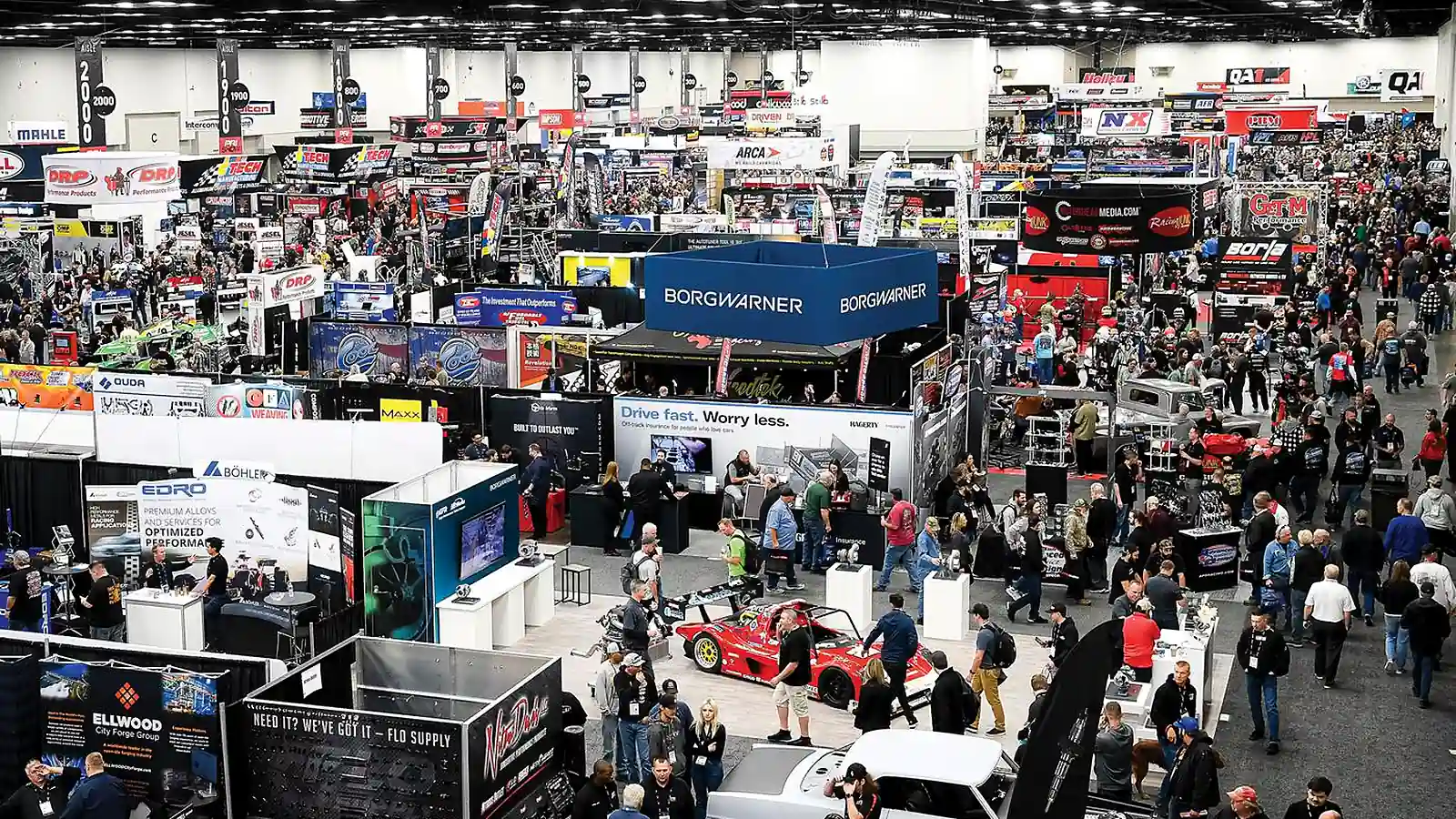 PRI Show floor in Indianapolis with motorsports exhibitors and race vehicles