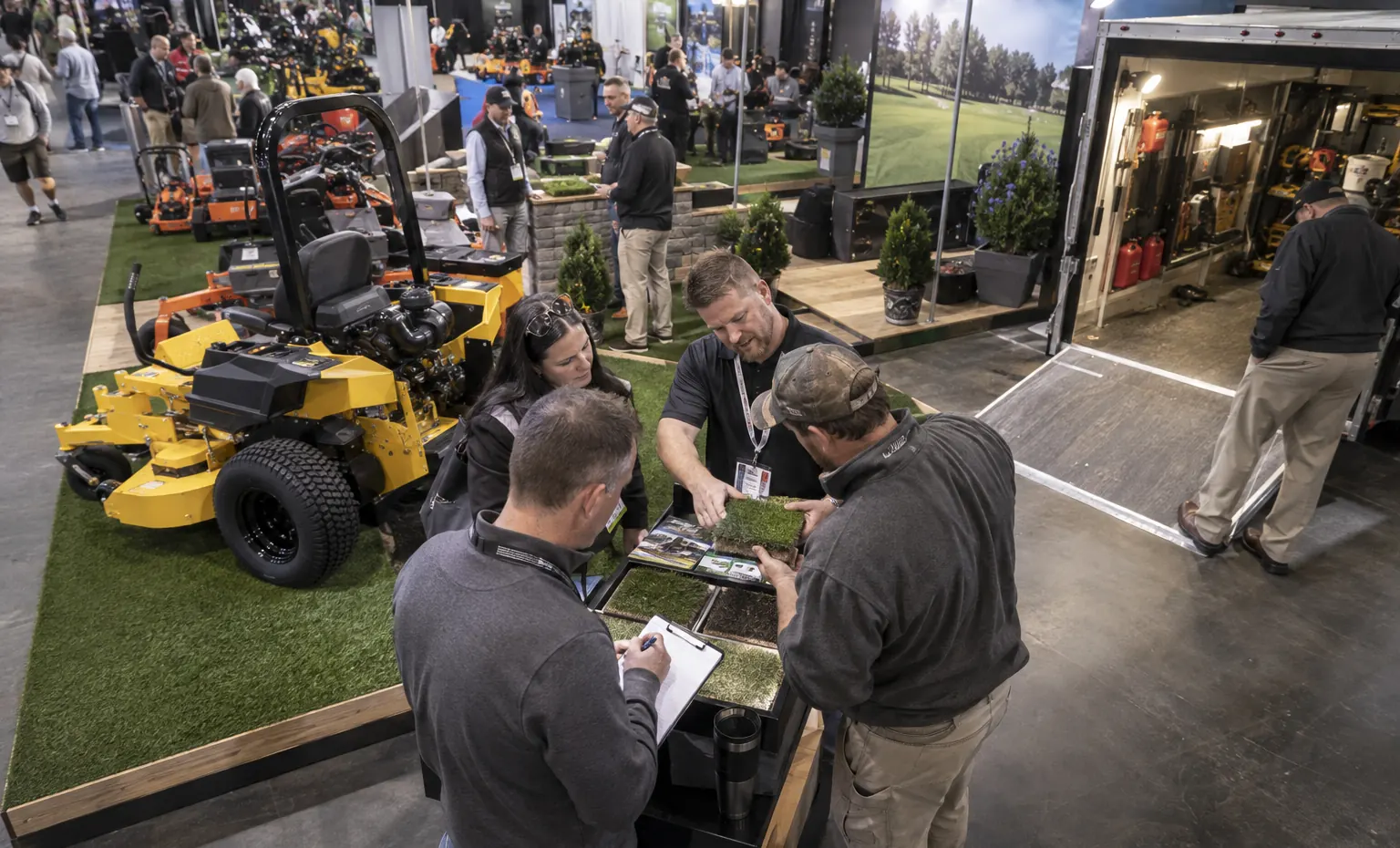 Bring the Demonstration Result Back to Sales trade show booth a full-scale equipment demonstration on a stable booth platform with service access visible