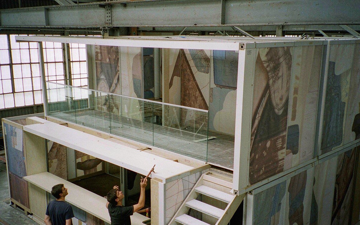double-deck booth structure trial-assembled in a tall workshop bay