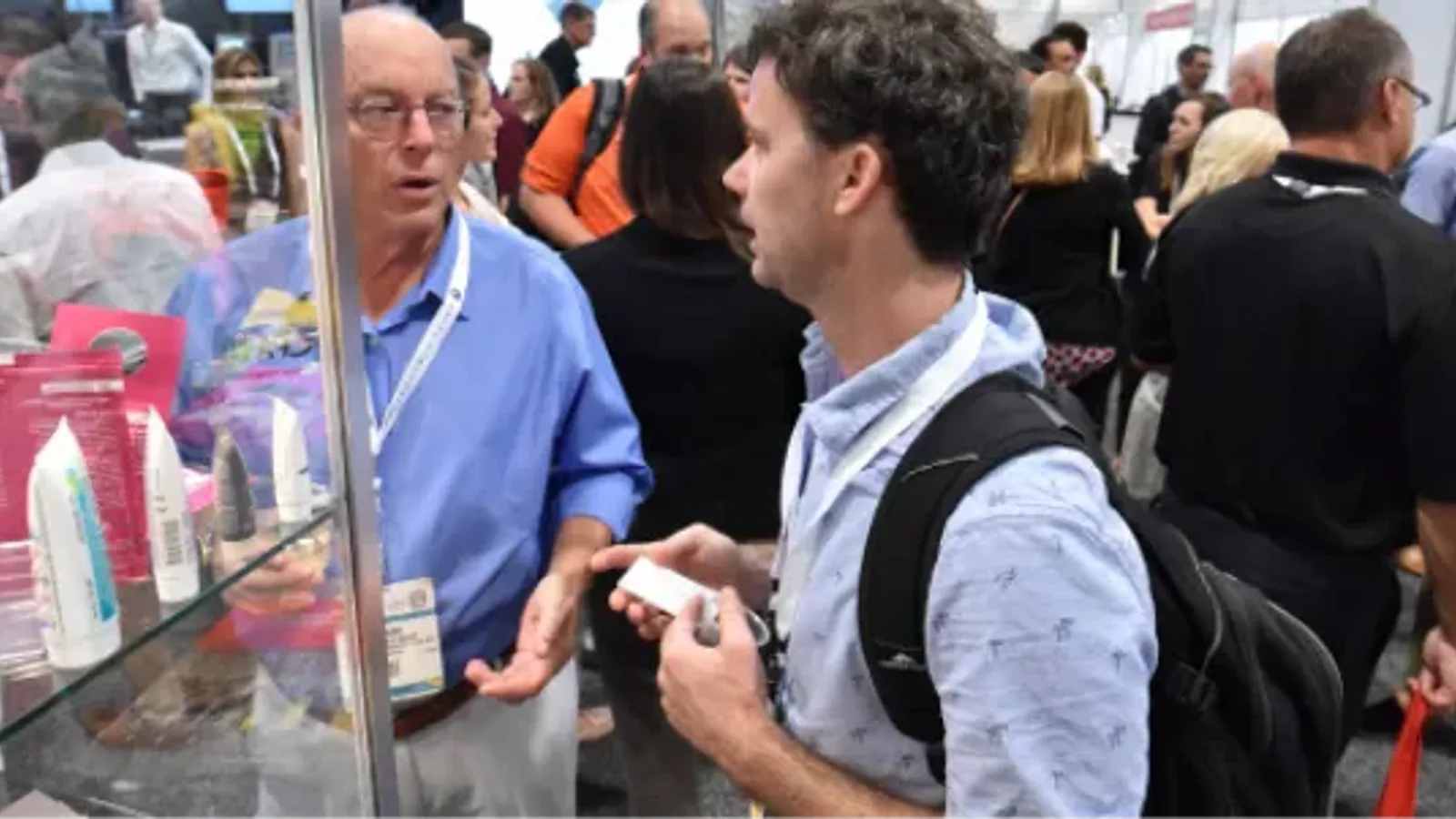Attendees discuss packaged products on the PACK EXPO Las Vegas 2025 show floor