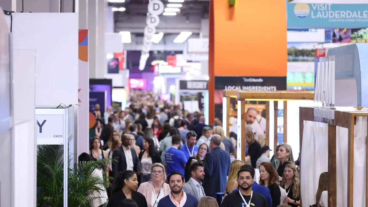 Busy IMEX America show floor with attendees and destination booths