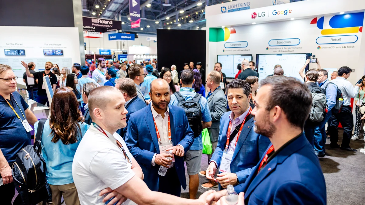 Attendees speaking with exhibitors on a previous InfoComm show floor.