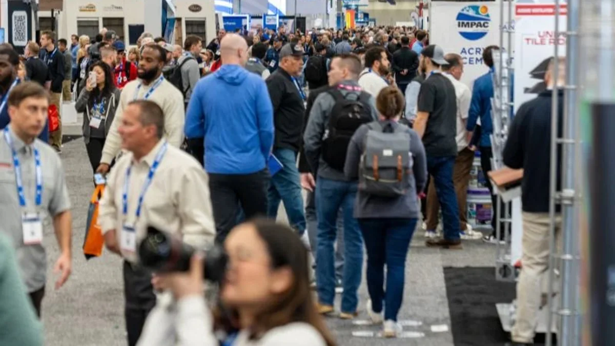 Attendees walking through busy aisles at a previous International Roofing Expo.