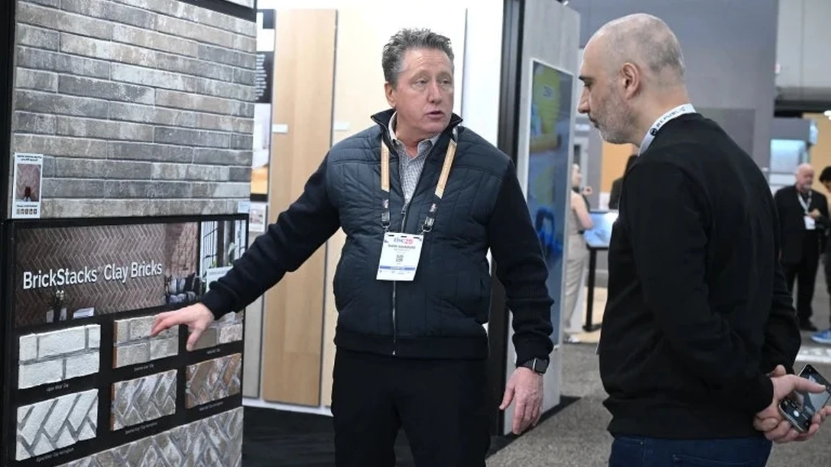Flooring professionals discussing brick samples on the TISE exhibition floor
