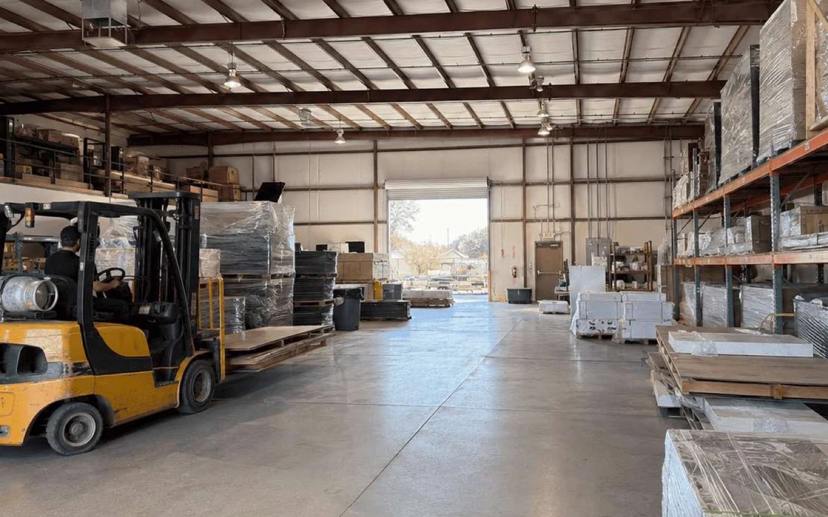 King Exhibits fabrication warehouse with materials and a forklift