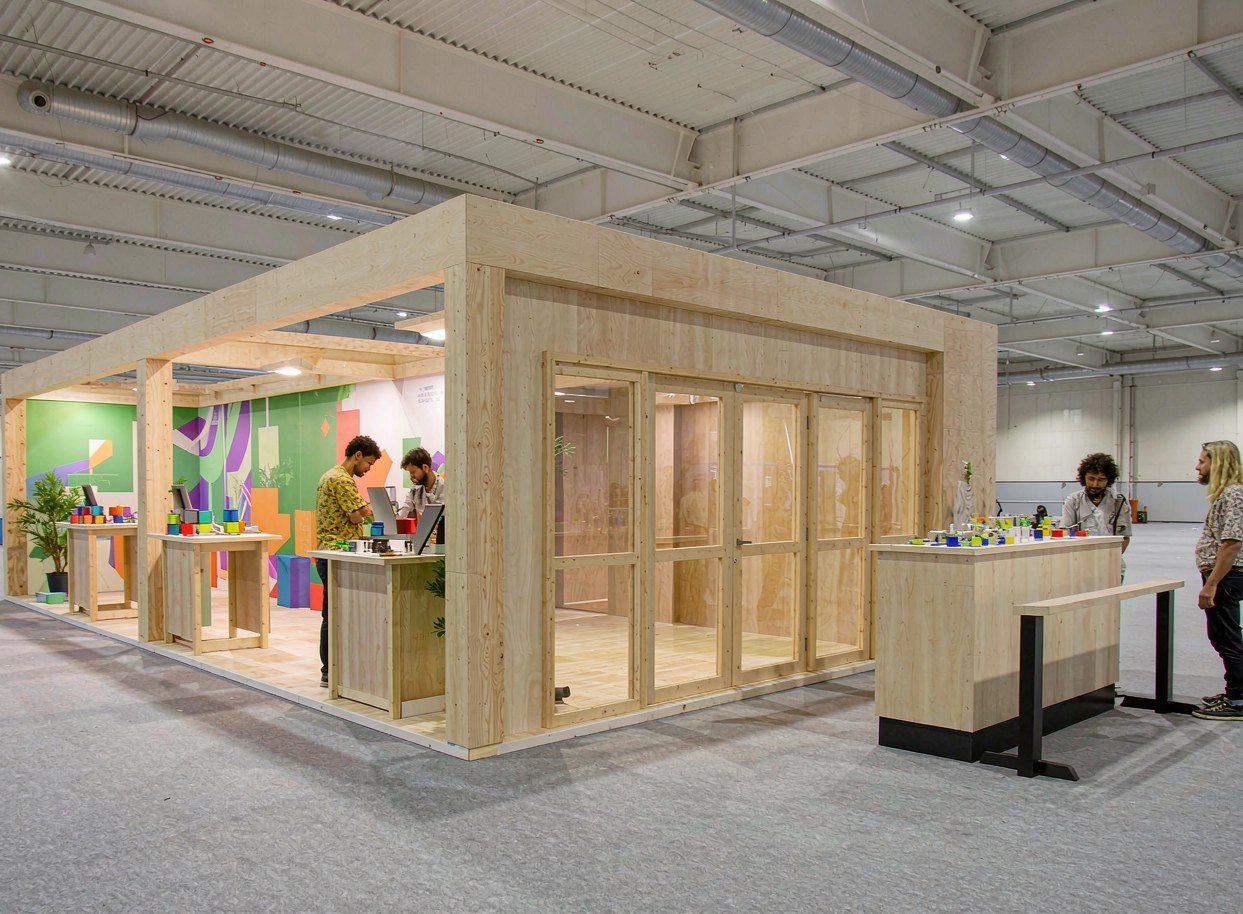 20x30 ft modular rental booth with two demo stations and an enclosed meeting room at the rear