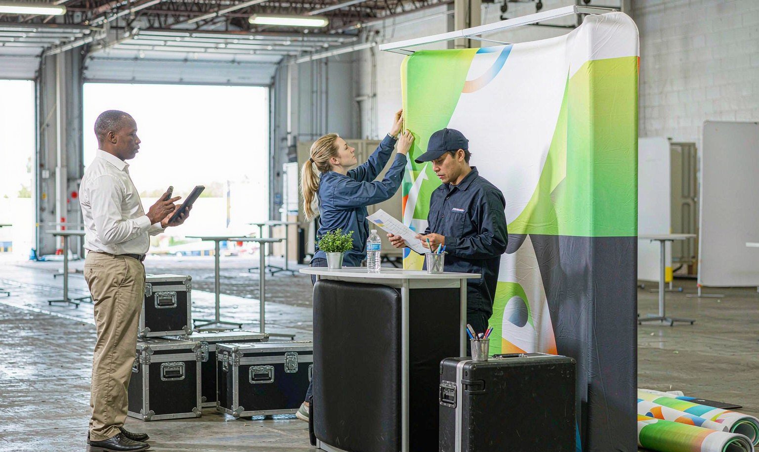 Project manager photographs a portable rental booth assembled during pre-build before shipping