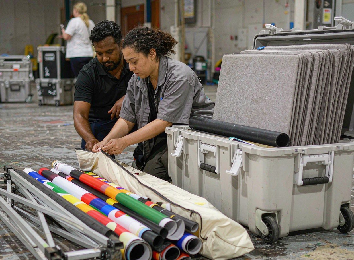 Portable trade show booth packed into wheeled bags, cases and rolled graphics before shipping
