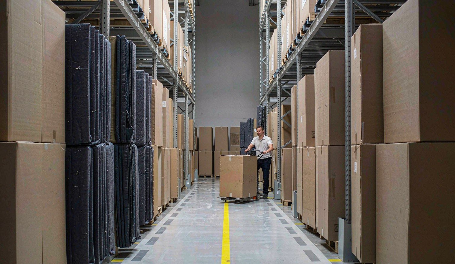 Stored exhibit crates and booth panels on racking in a clean warehouse - Trade Show Exhibit Storage