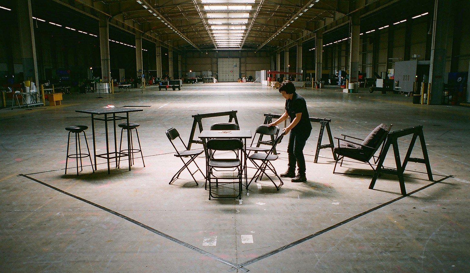 Rental furniture layout mock-up with tables and seating in a staging warehouse - Trade Show Rental Furniture