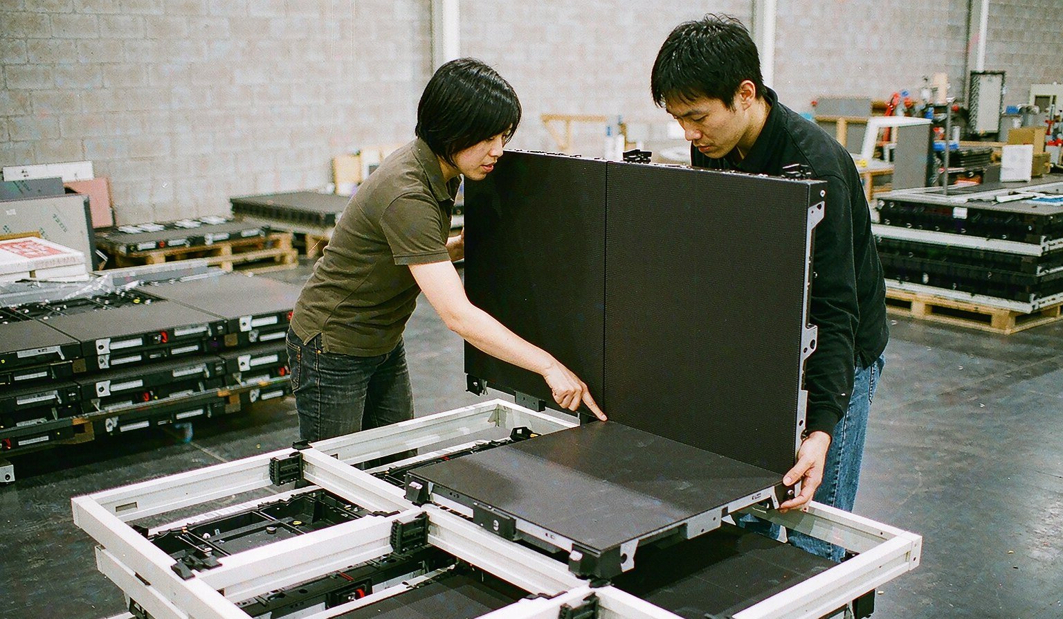 LED wall modules being aligned into a frame in the workshop - Trade Show Video Wall Rental