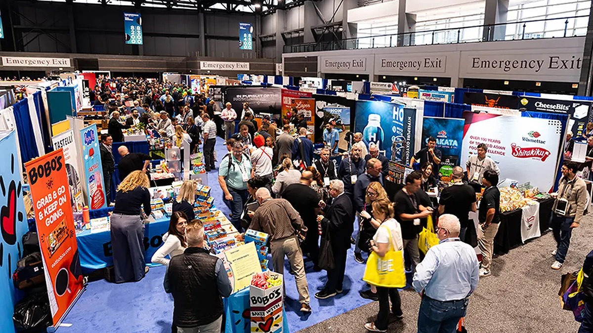 Attendees walking the NACS Show exhibition floor