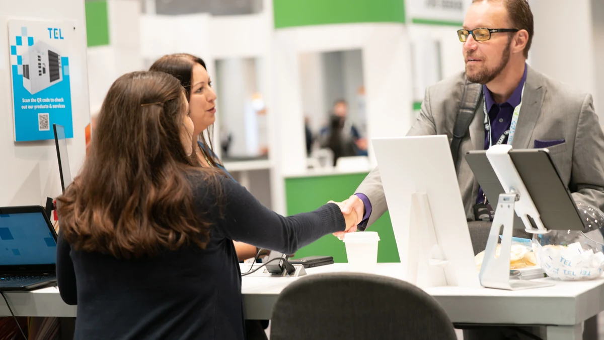 A business meeting at an exhibitor booth during a previous SEMICON West.