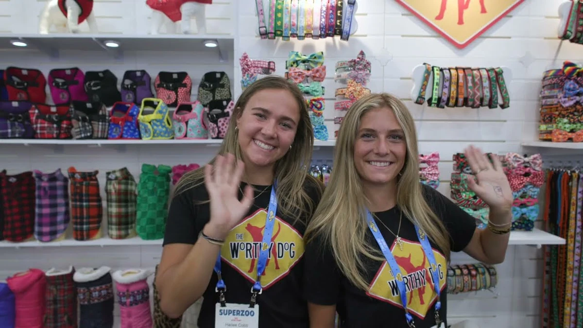 SUPERZOO staff welcoming buyers at a pet-products booth in an official show video.