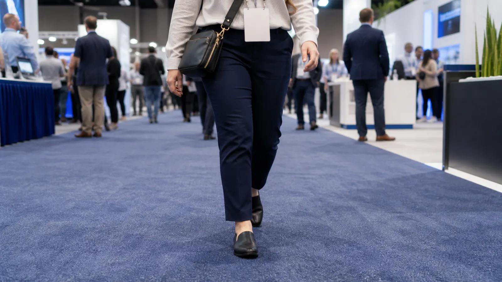 Professional wearing supportive shoes while walking a trade show floor